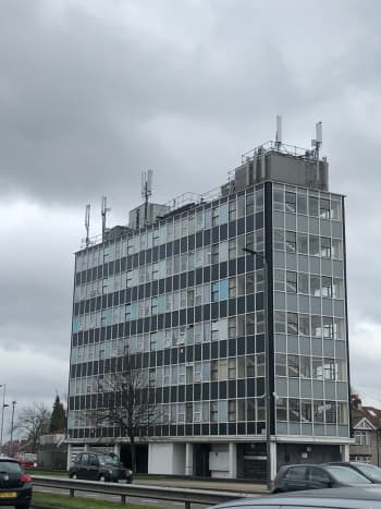 Large multi-storey building with rows of square glass windows
