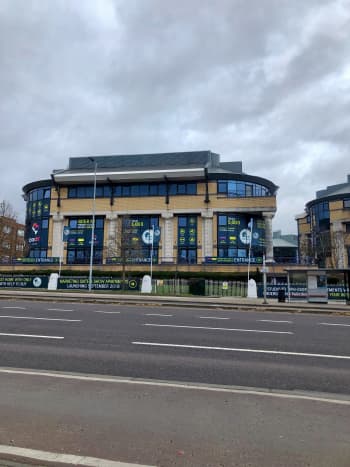 Converted commercial building next to a road with signs advertising new apartments