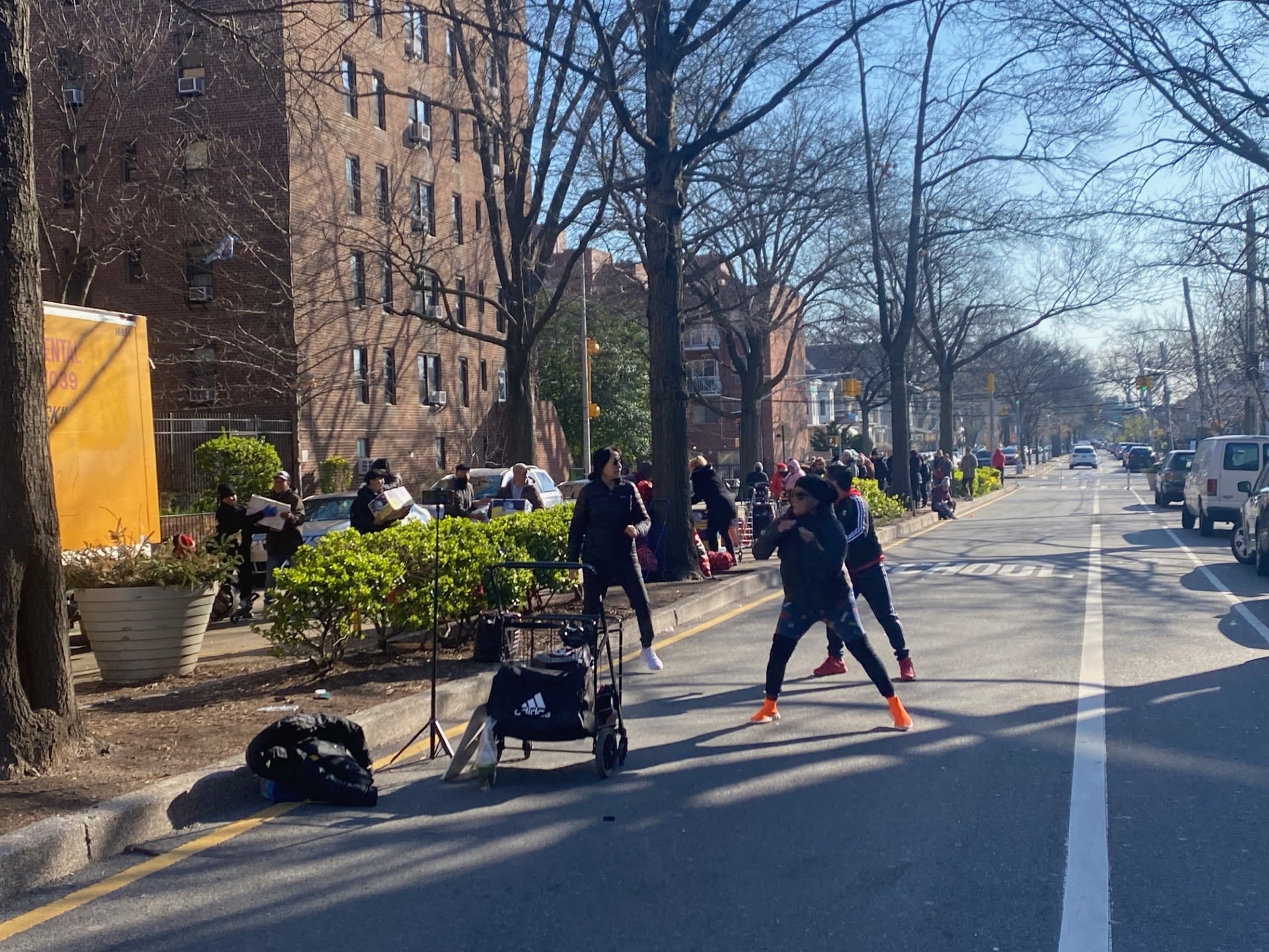 People exercising in gym clothes on a residential street
