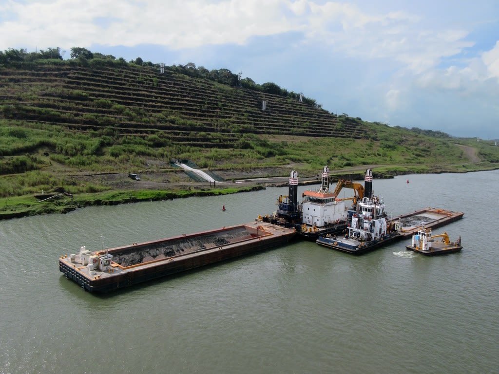 a large dredging ship in wide canal