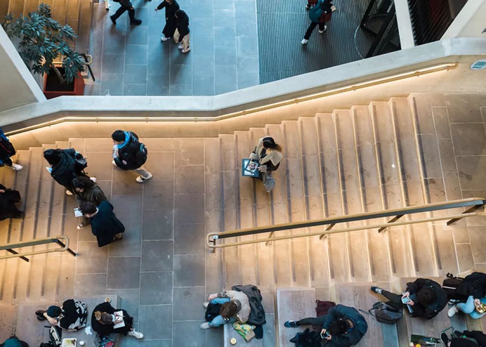 Students walking down stairs ucl campus