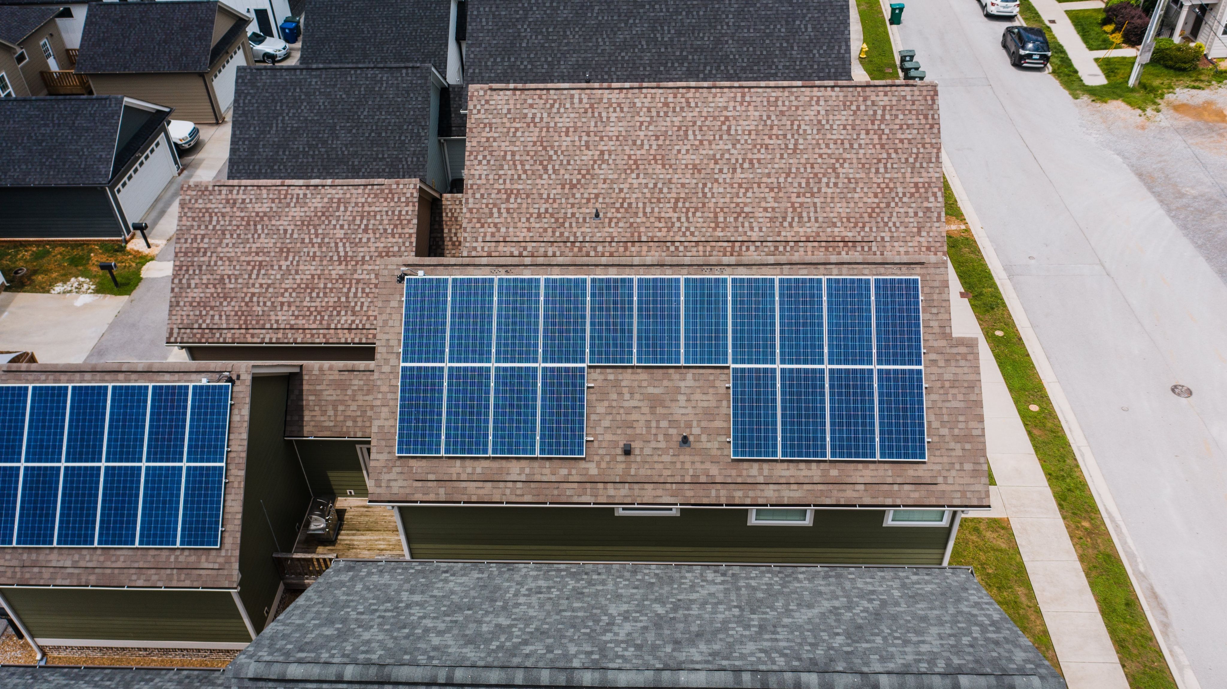 Aerial view of a house roof with solar panels