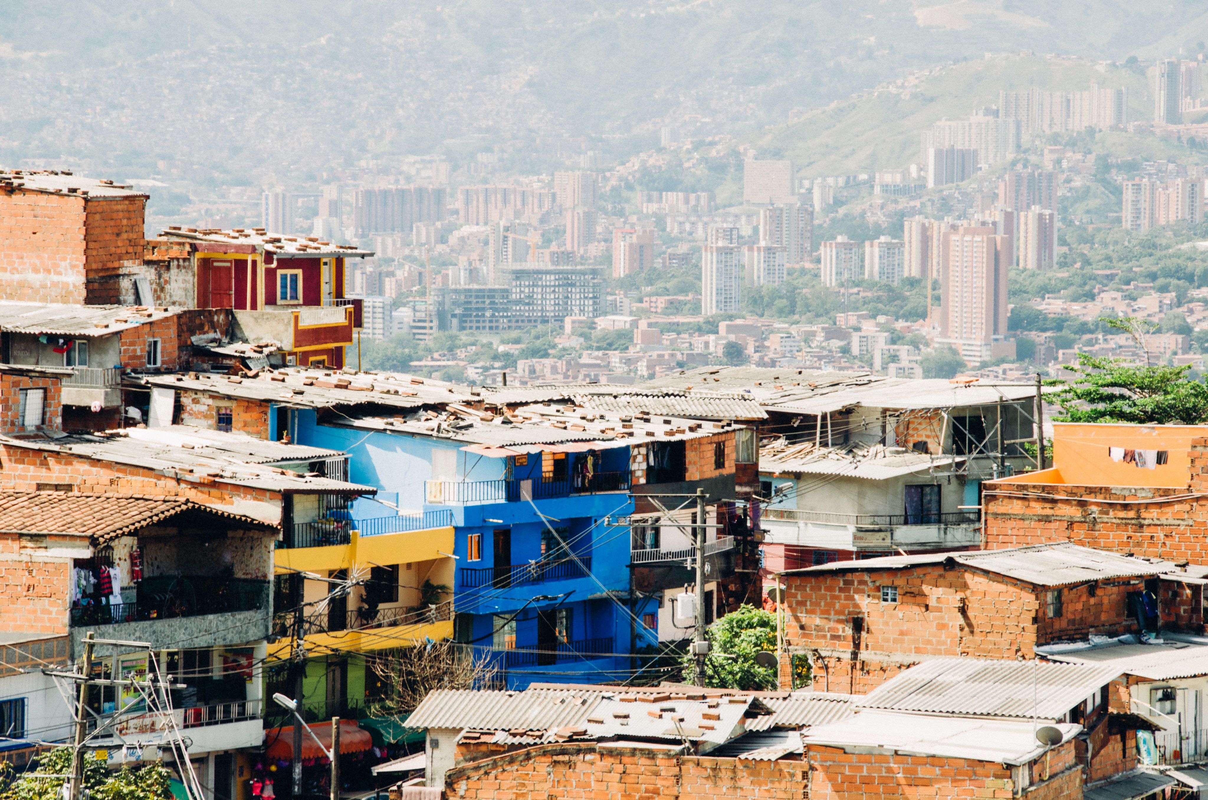 favela in forefront with tall buildings in background