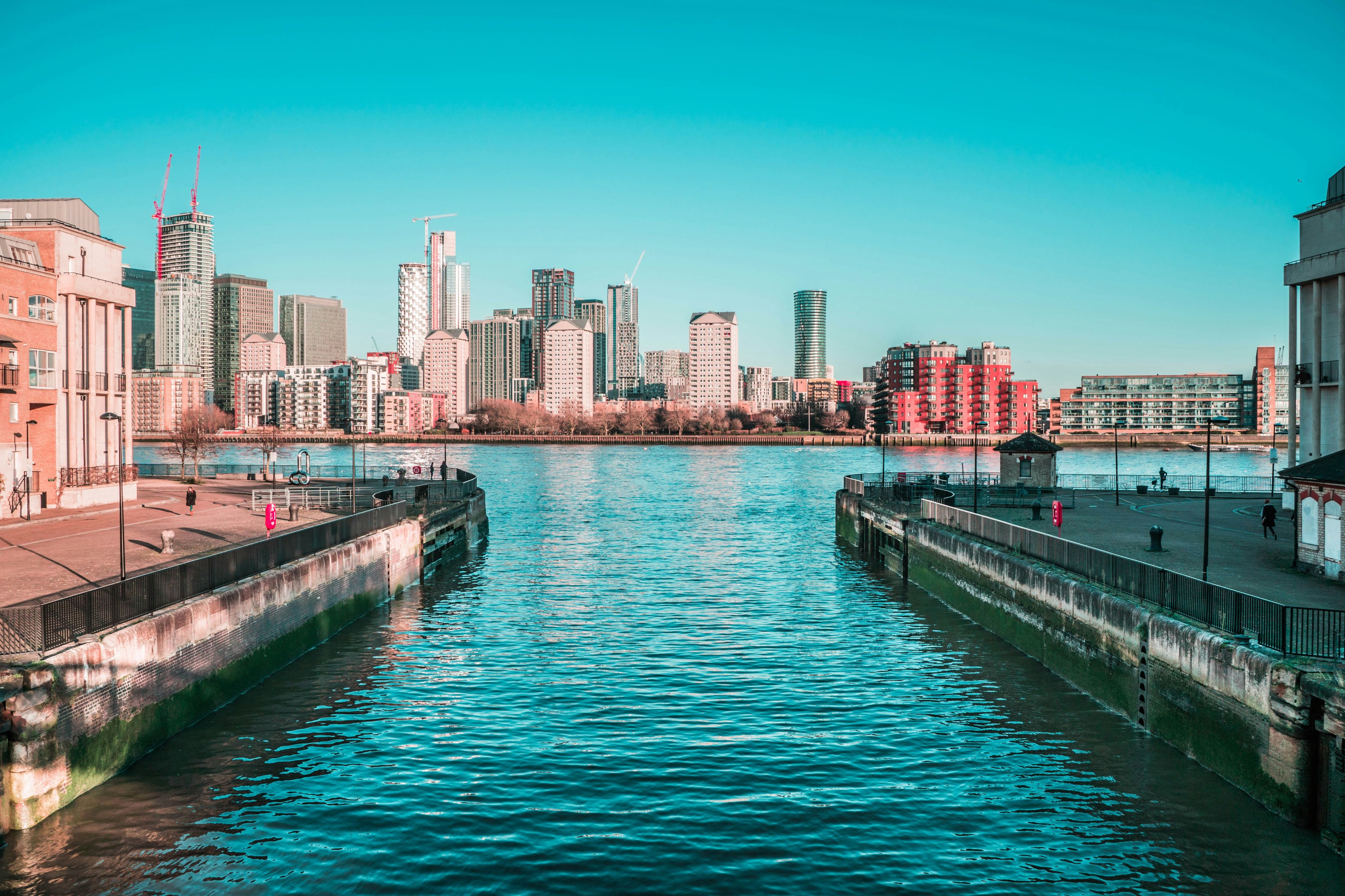 body of water near city buildings during daytime
