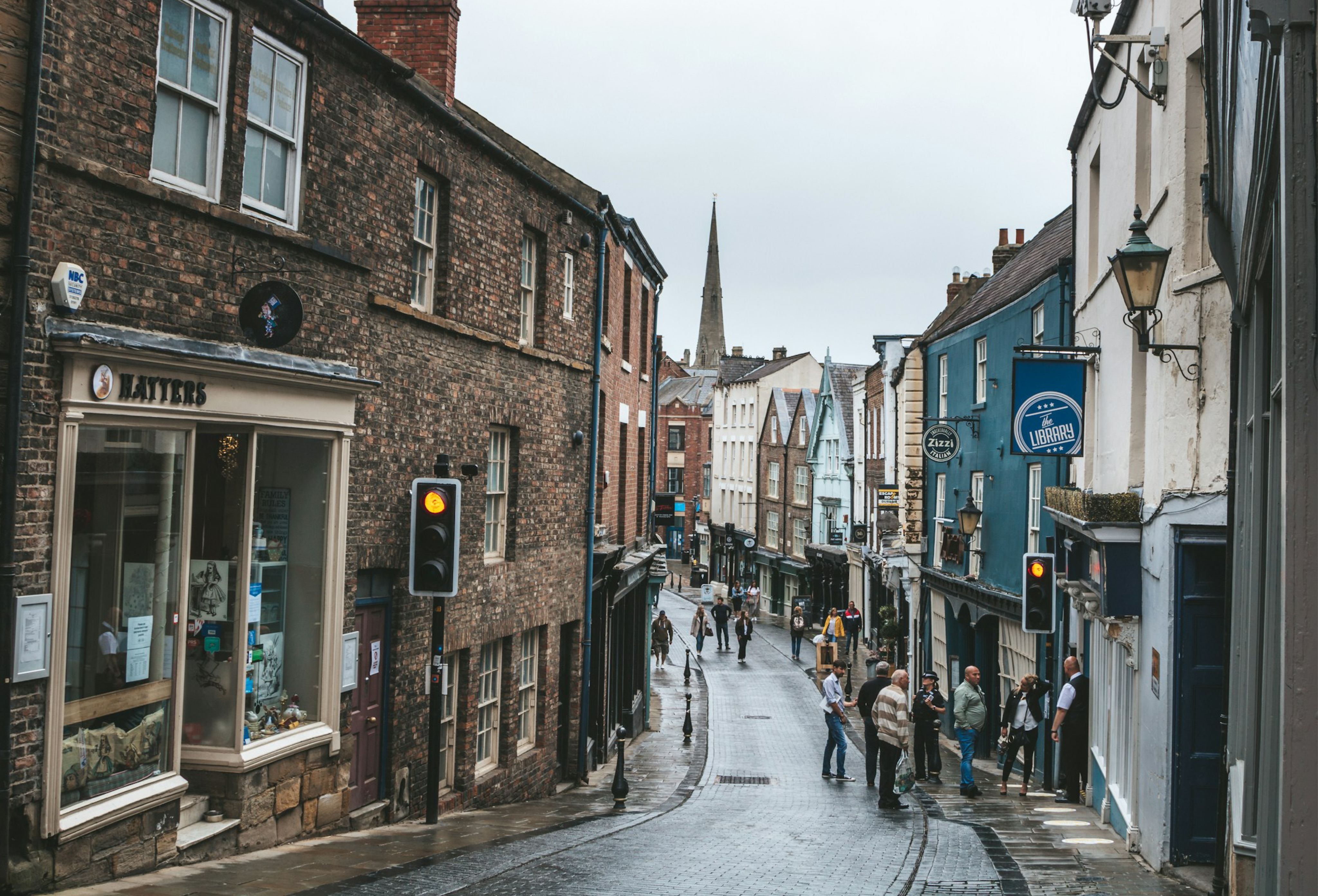people walking on street between buildings during daytime