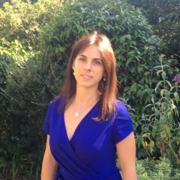 Catherine Fitzgerald standing in front of a green bush