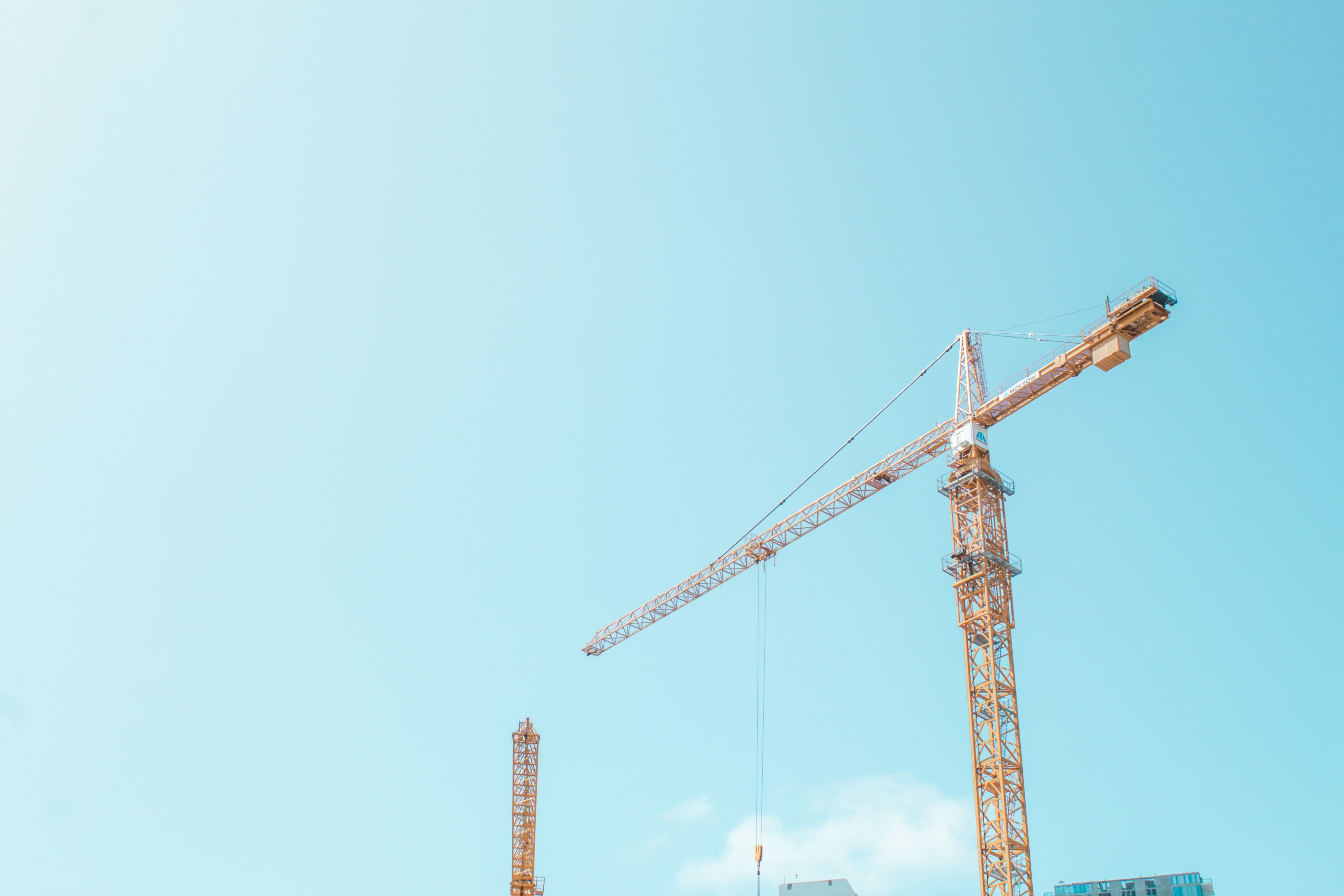 orange crane under white sky
